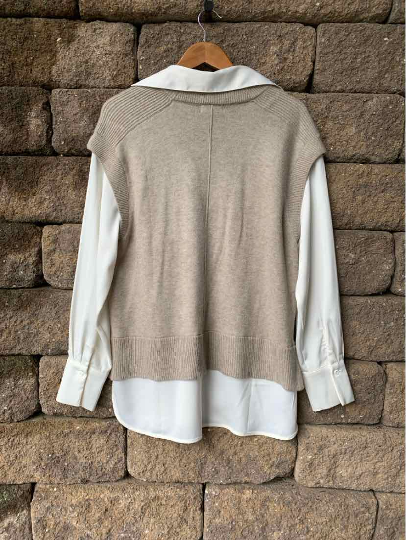 Beige sleeveless knit vest layered over white long-sleeve shirt with buttoned cuffs.