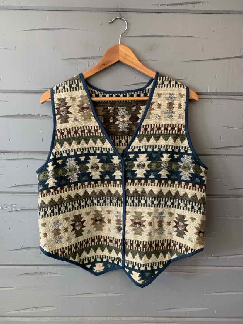 Women’s sleeveless black, cream, and teal geometric knit vest with a deep V-neck and button front.