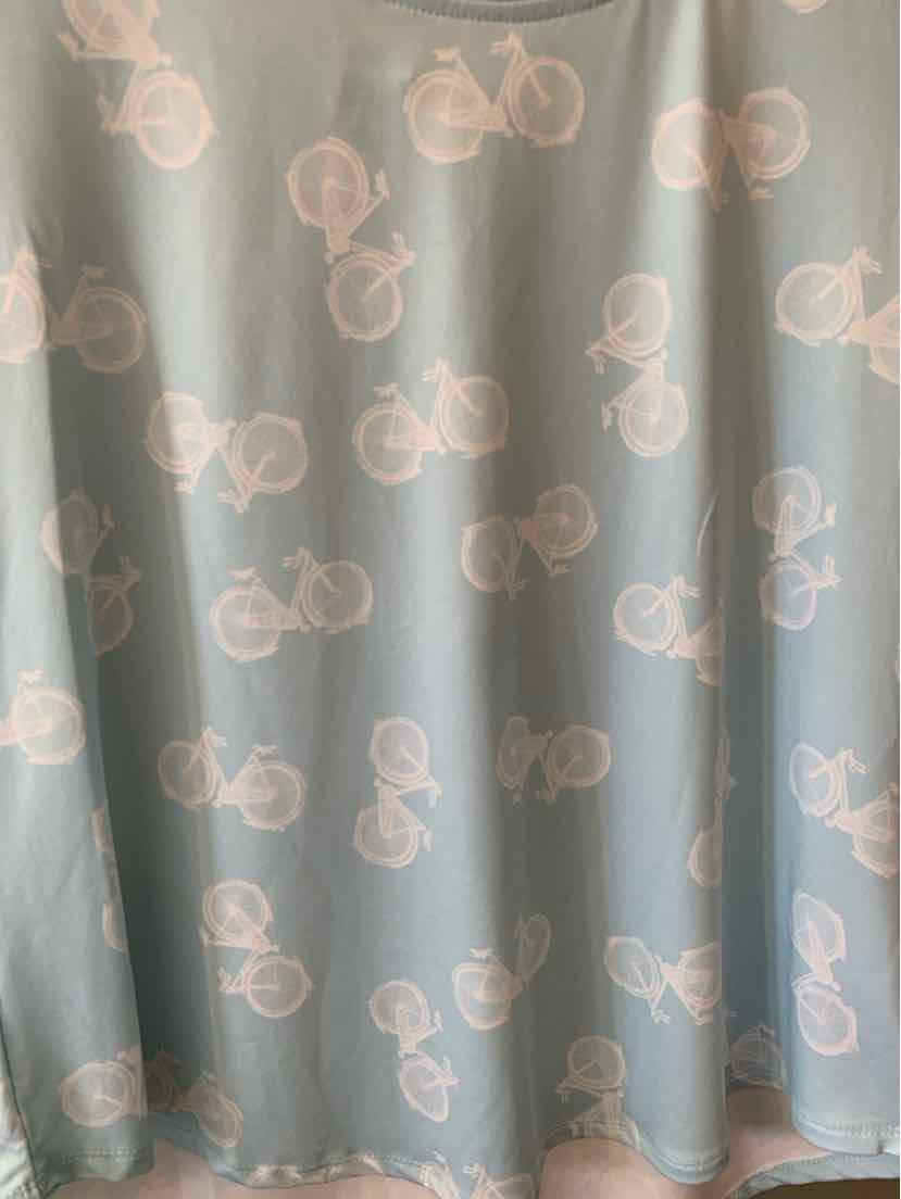 Light blue fabric with repeating white bicycle pattern, soft and flowing material.