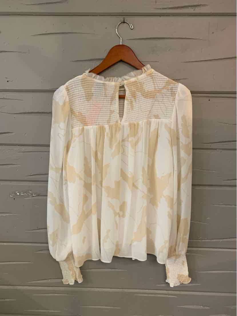 Long-sleeve blouse with cream and beige floral pattern, lightweight fabric, gathered cuffs, and keyhole neckline button.