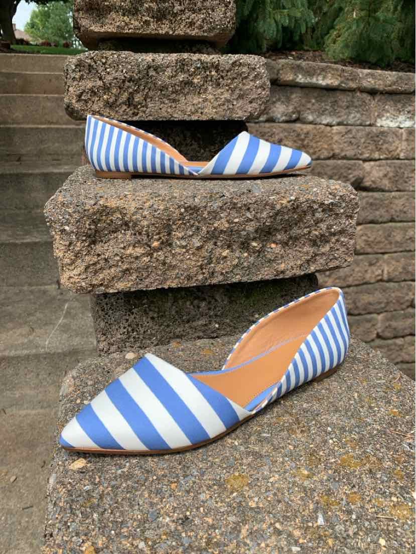 Blue and white striped pointed-toe flat shoe with tan interior lining.