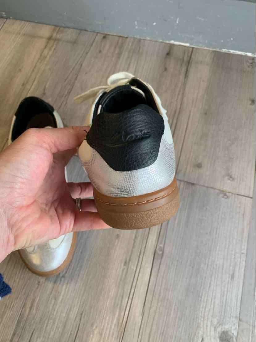 White and black sneaker with gum sole, leather upper and black heel tab, size 10.