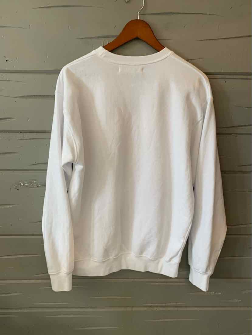 White long-sleeve crewneck sweatshirt with ribbed cuffs and hem, displayed on wooden hanger.