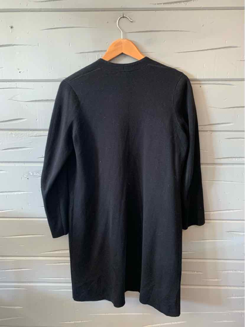 Black long-sleeve knee-length knit dress with a straight silhouette and crew neckline hanging on wooden hanger.