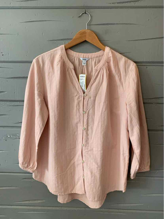 Light pink long-sleeve blouse with round neckline and button placket, relaxed fit, lightweight fabric.