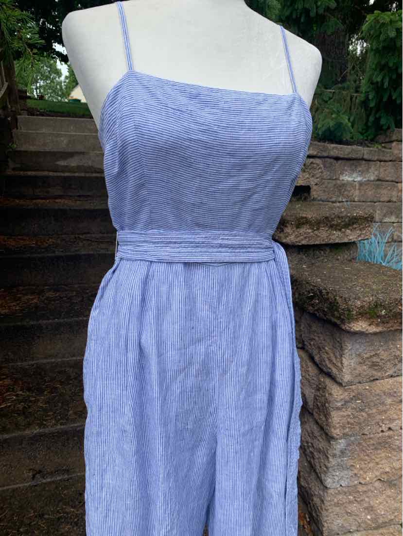 Light blue sleeveless dress with thin straps and a fitted waist belt on a white mannequin.
