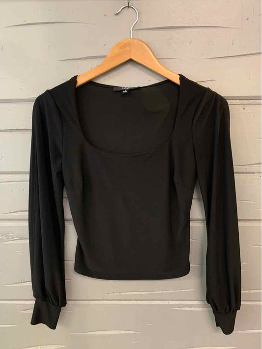 Black long-sleeve fitted top with scoop neckline and slight puff sleeves on wooden hanger.