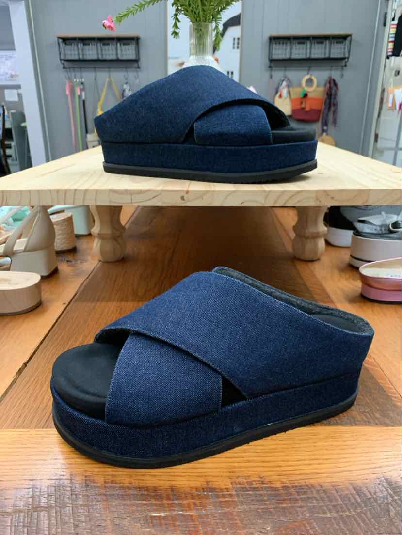 Wedge platform sandals in navy blue fabric with crisscross straps and open toe design.