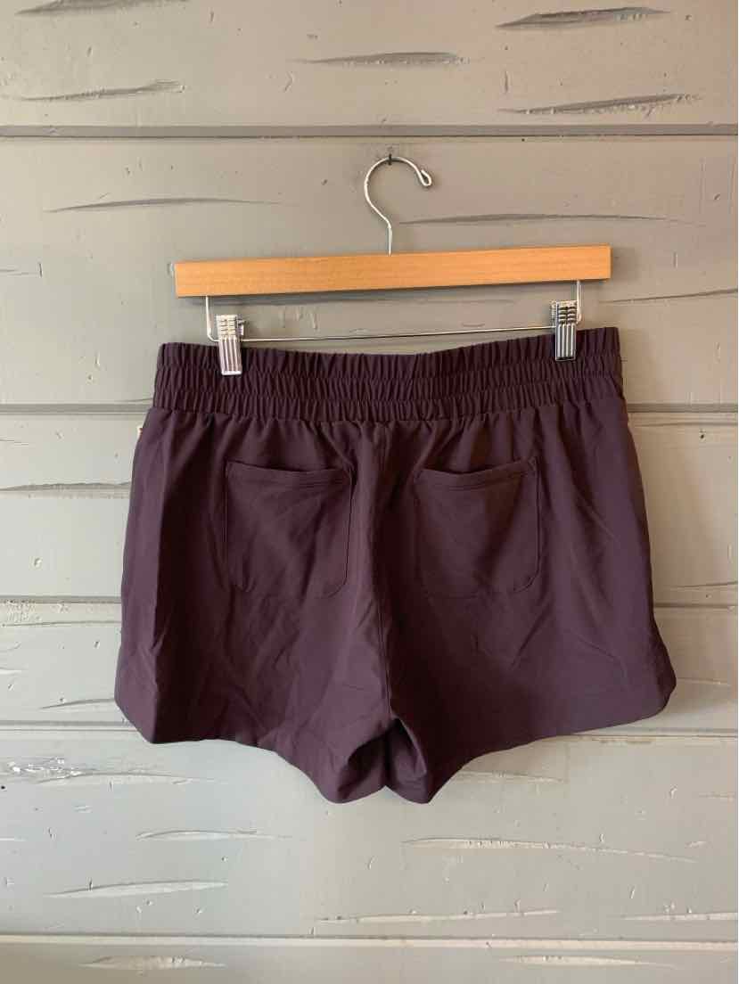 Dark brown lightweight athletic shorts with an elastic waistband and back pocket, medium size.