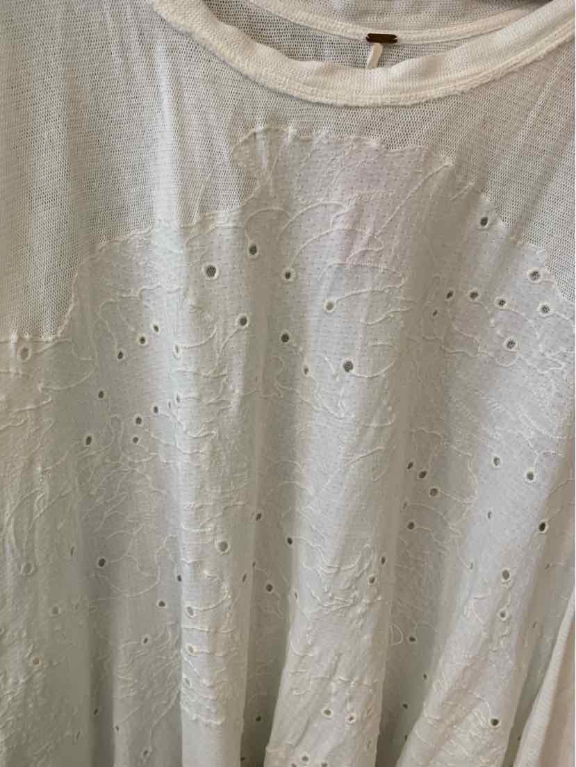 White medium-size Free People T-shirt with subtle perforated floral design.