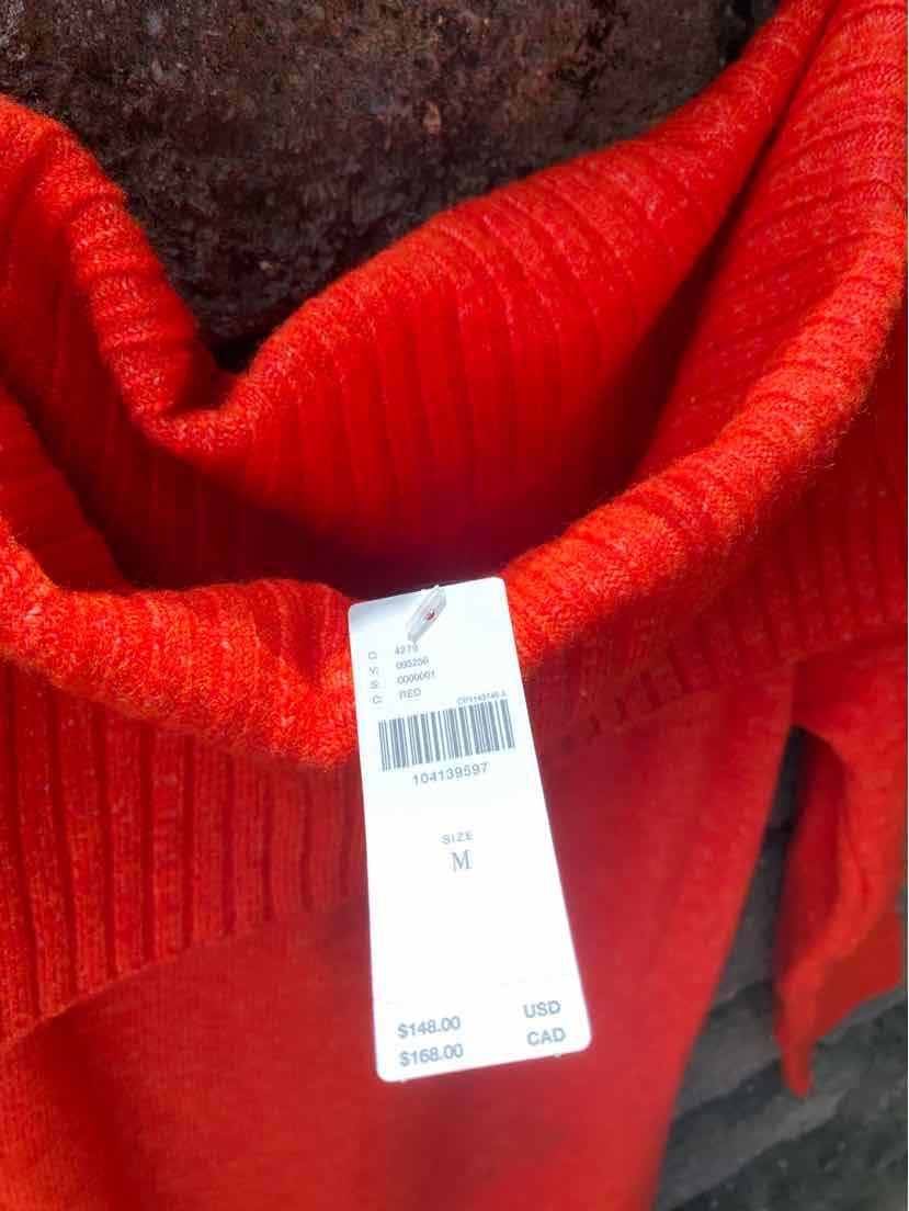 Bright red ribbed knit sweater with a folded collar and white product tag attached.