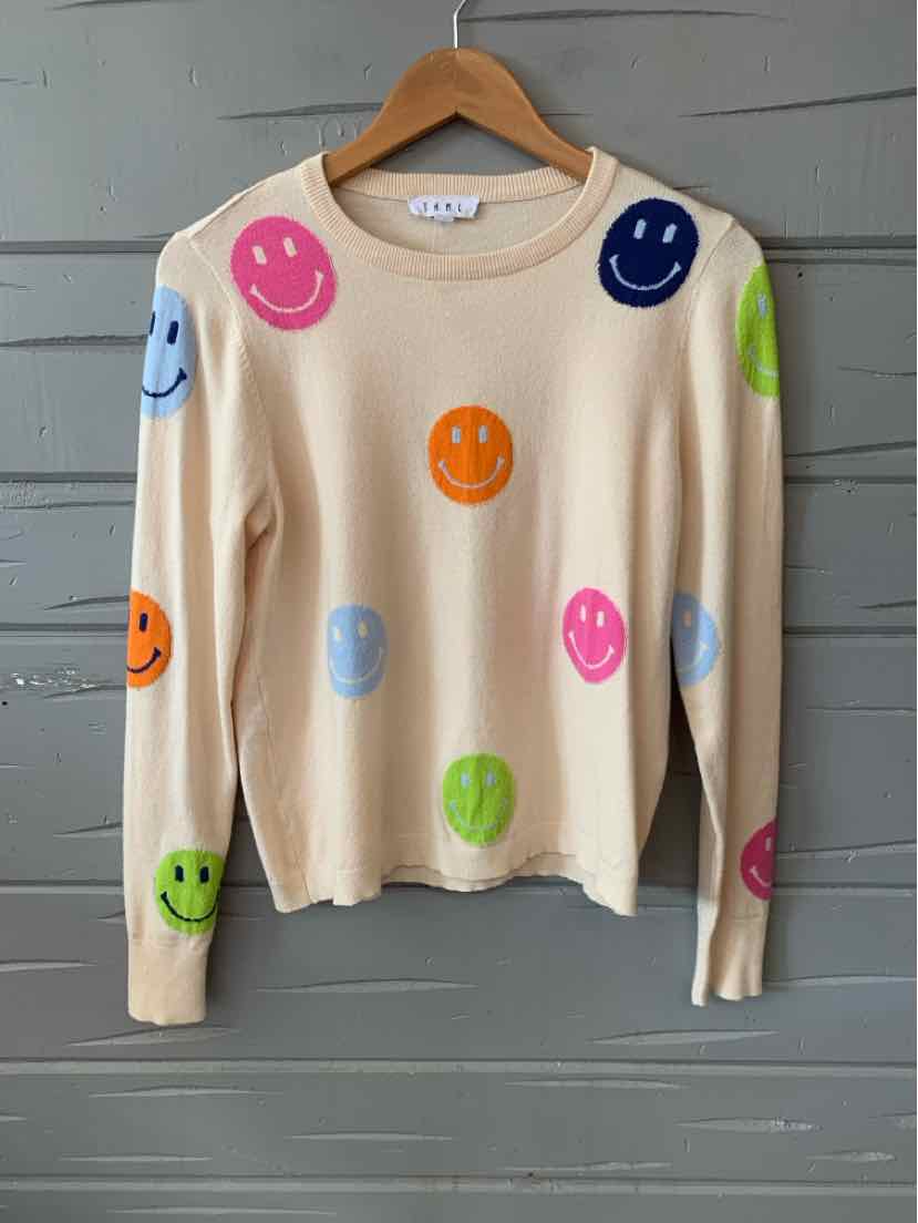 Tan long-sleeve crewneck sweater with colorful smiley faces in various sizes scattered across the fabric.