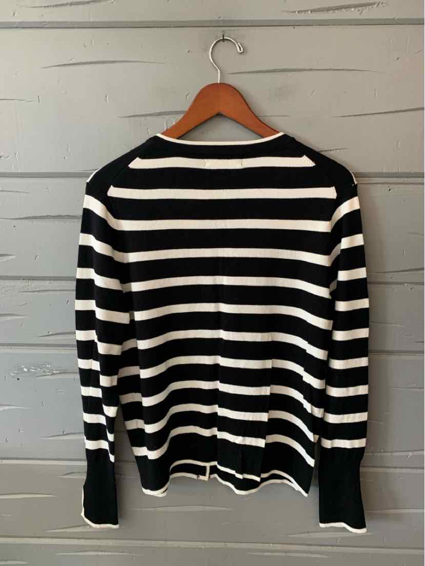 Black sweater with horizontal white stripes, long sleeves, and a rounded neckline.