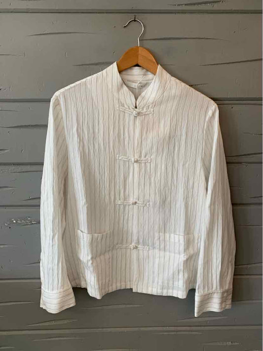 White fitted blouse with vertical stripes, mandarin collar, and toggle button closures.