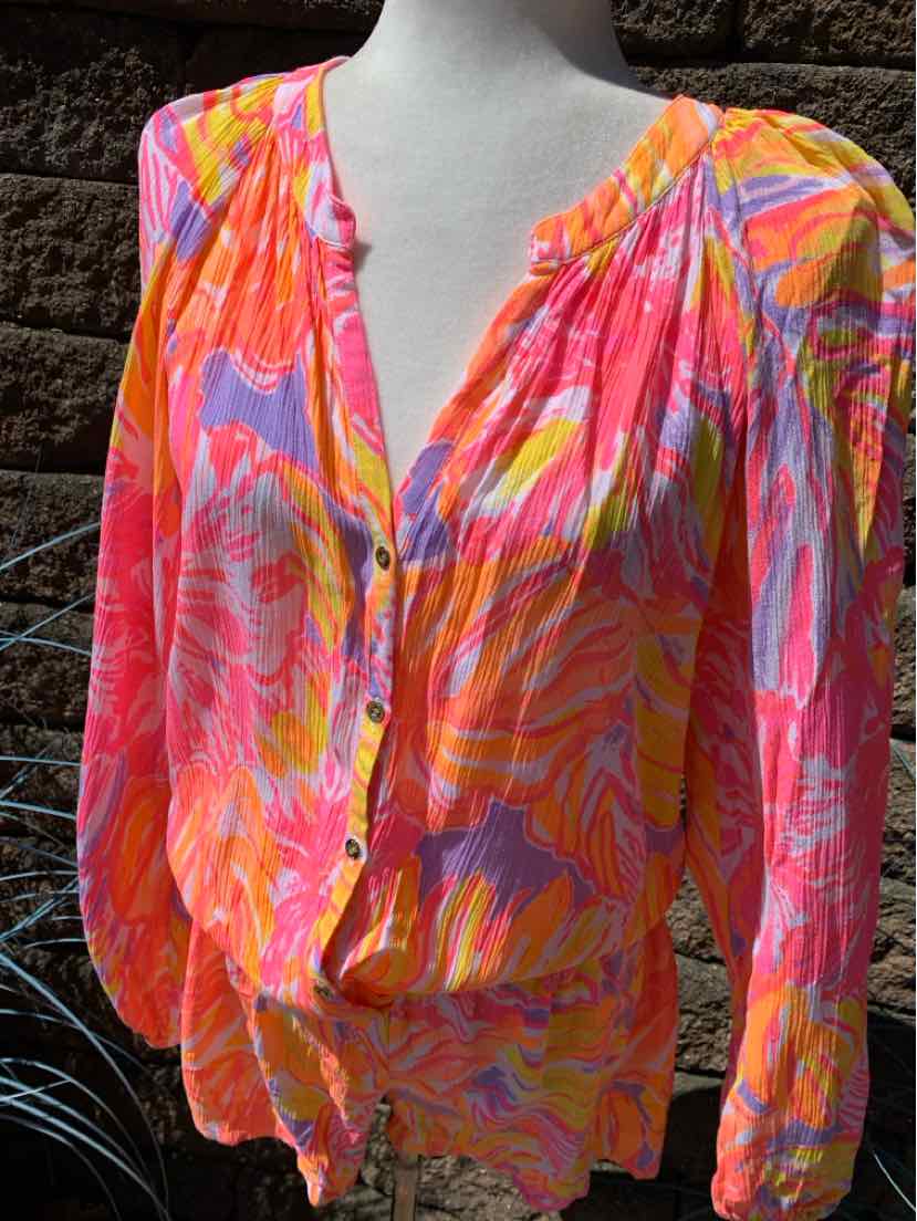Colorful floral blouse in pink, orange, and lavender with button front and gathered neckline.