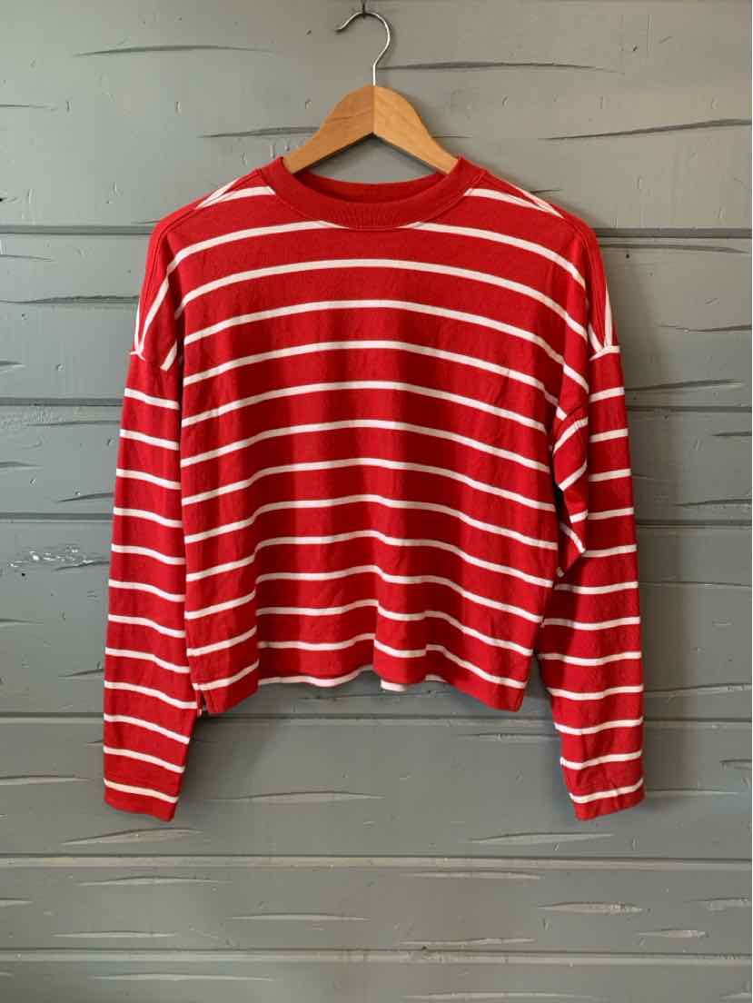 Red long-sleeve crewneck sweater with white horizontal stripes, loose fit, and ribbed cuffs.