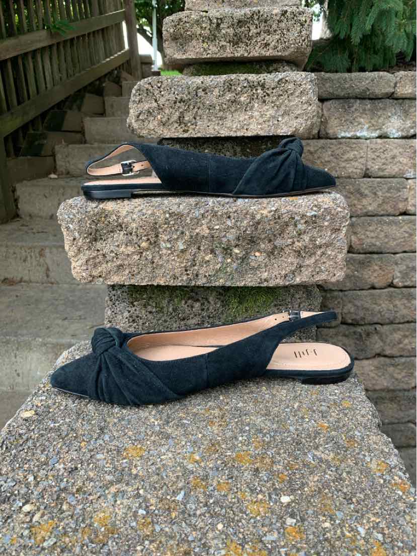 Black flat slingback shoes with knotted fabric front and open heel, size 8.