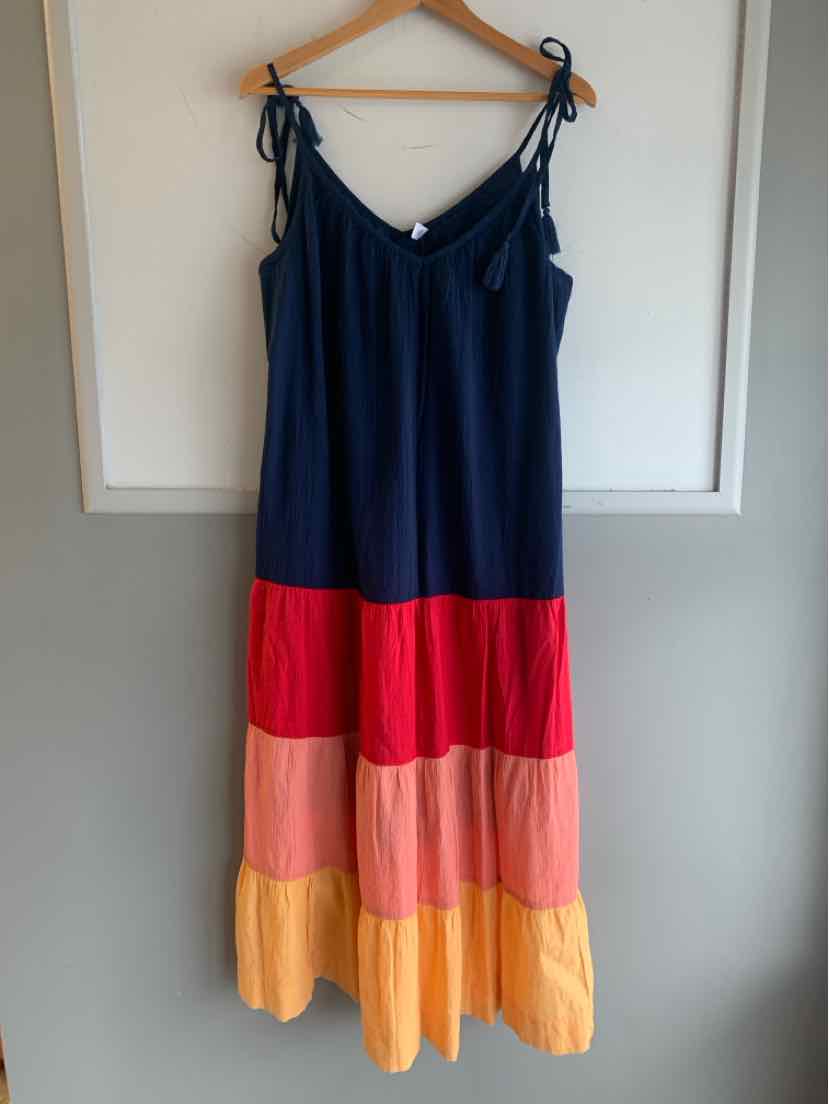 Navy blue sleeveless dress with adjustable tie straps and color block tiers in red, pink, and yellow.