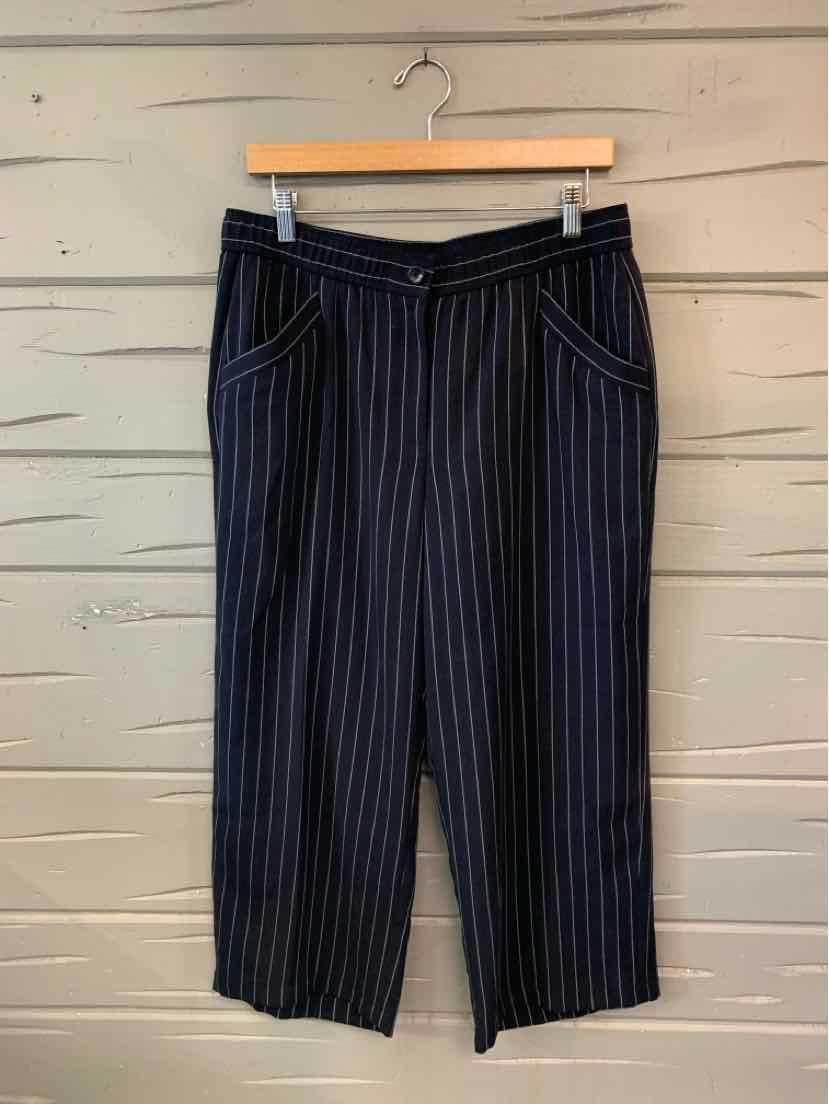 Navy blue cropped pants with thin vertical white pinstripes and front pockets.