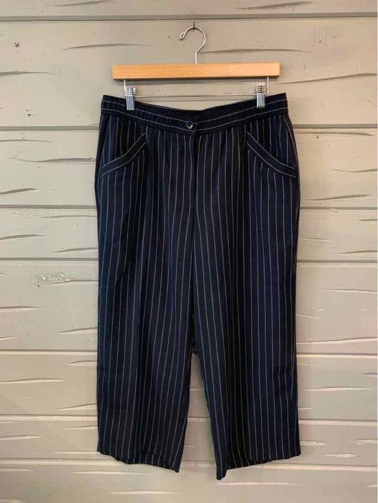 Navy blue cropped pants with thin vertical white pinstripes and front pockets.