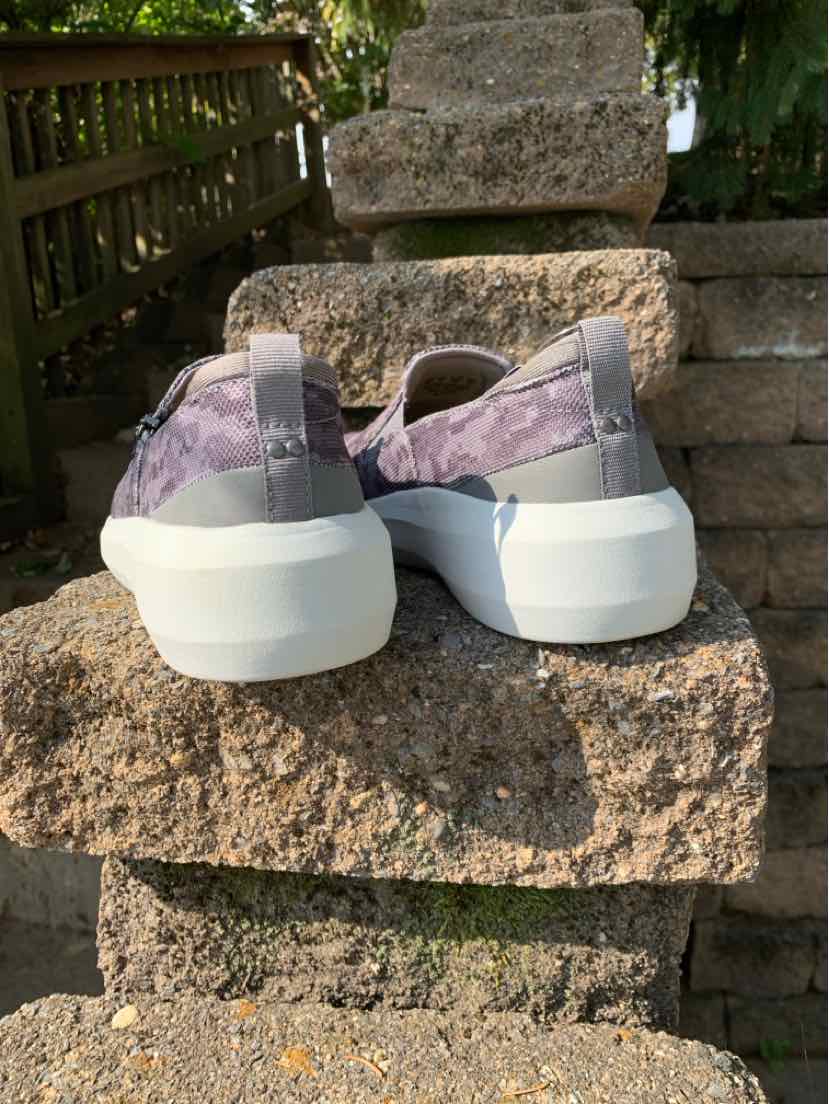 Women’s gray Ryka sneakers with lavender patterned mesh uppers, white soles, and heel pull tabs.
