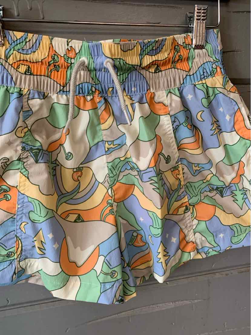 Women's athletic shorts with elastic waistband, colorful abstract floral print in blue, green, orange, and beige.