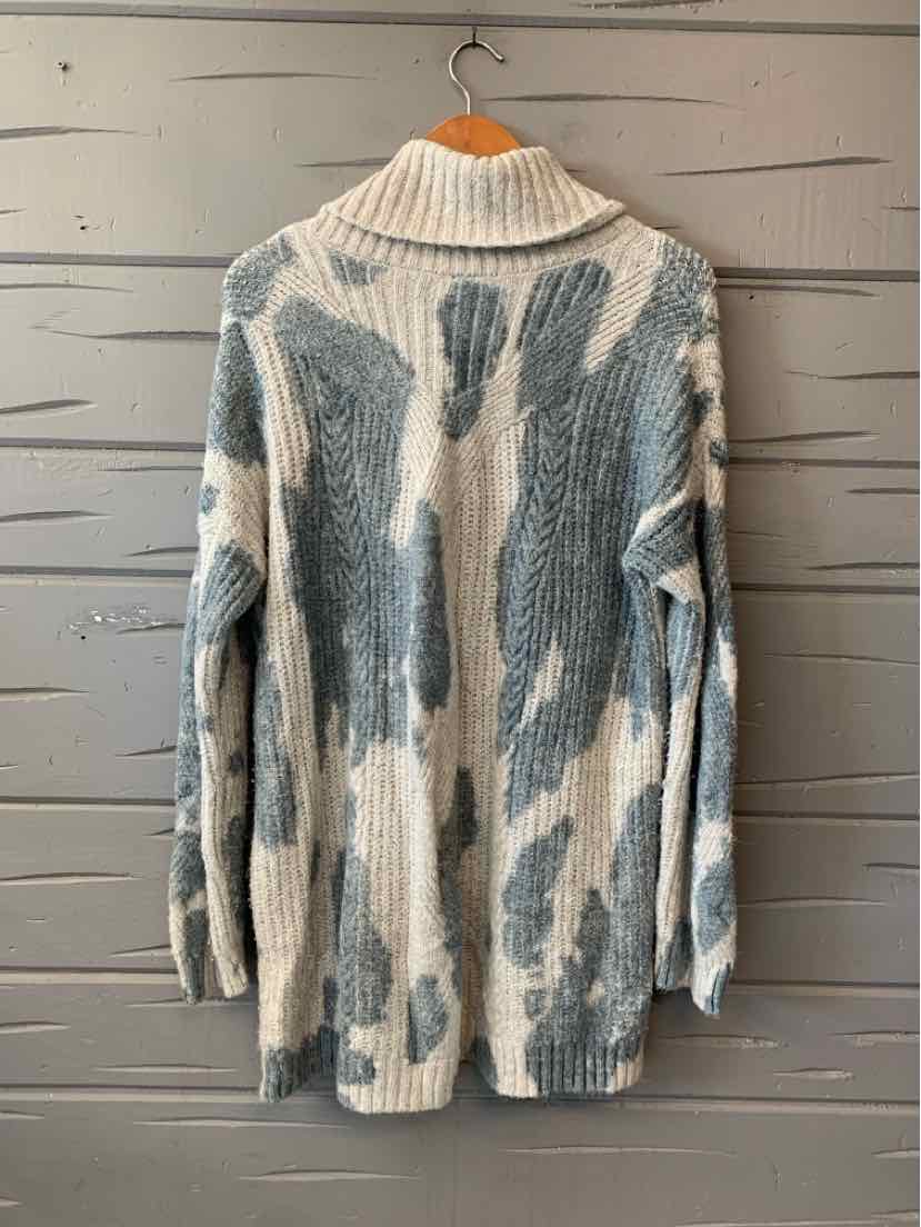 Long chunky knit cardigan with blue and white abstract pattern and a wide ribbed collar.