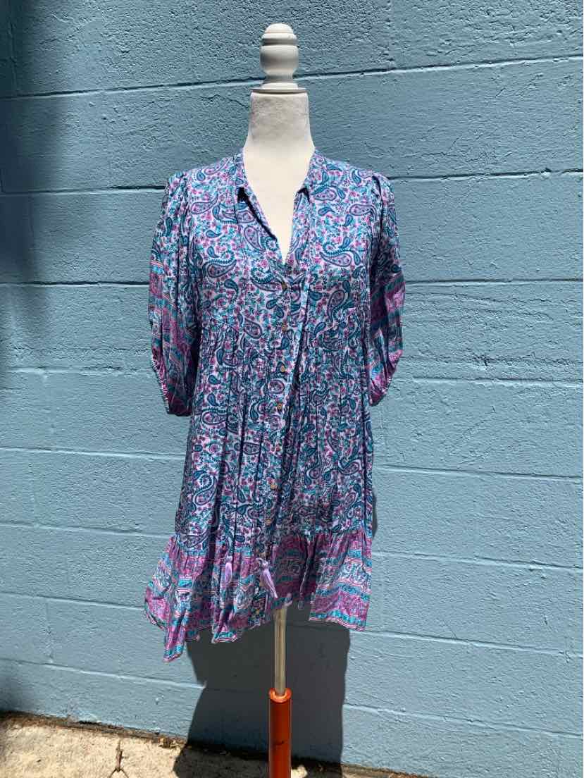 Short-sleeve V-neck dress with ruffled hem in blue and pink floral pattern, lightweight fabric.