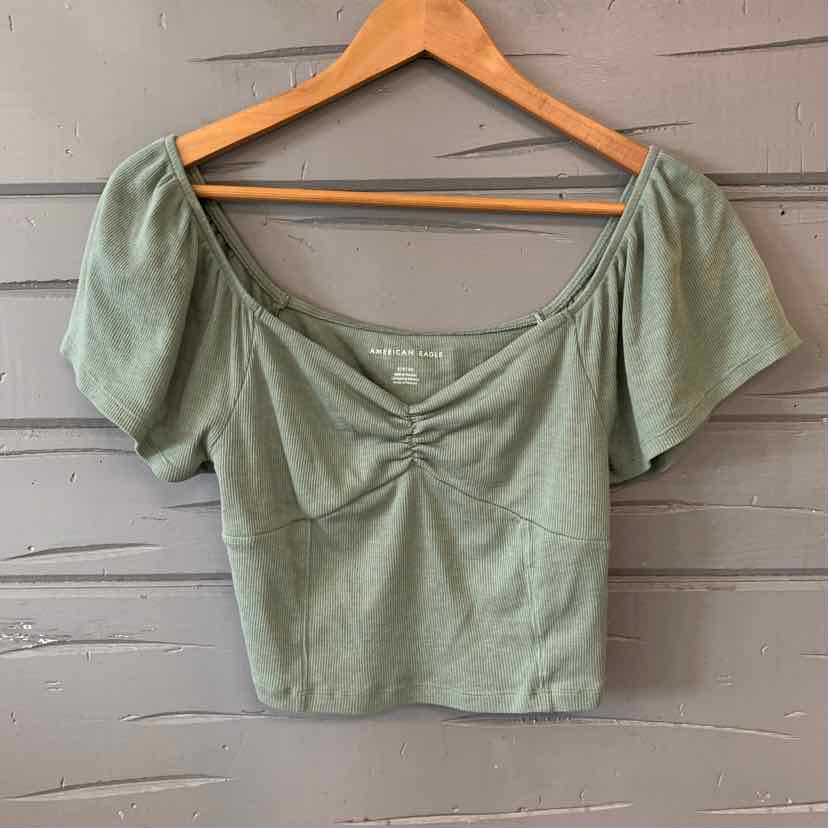 Sage green short puff sleeve crop top with sweetheart neckline and ruched detailing.