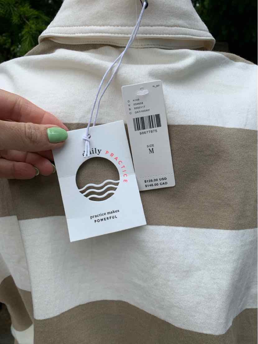 Tan and white wide striped shirt with double tags hanging from the collar.