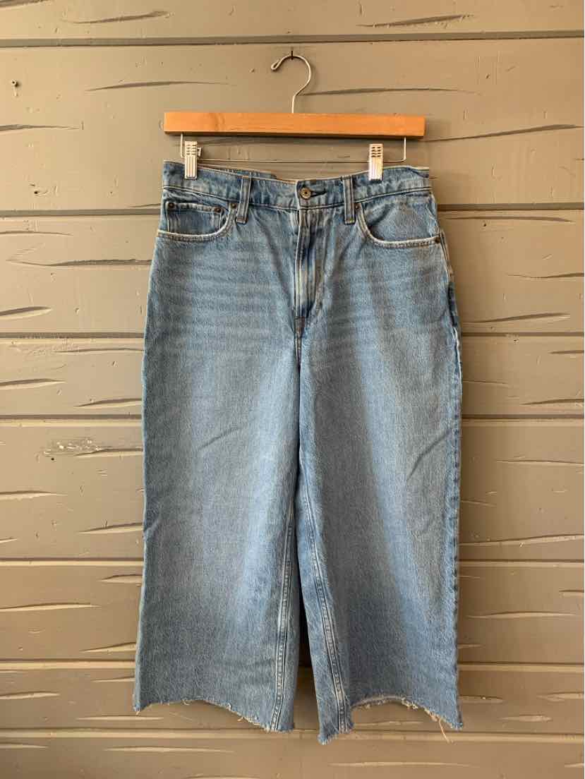 Light blue wide-leg cropped jeans with frayed hems and classic five-pocket design.