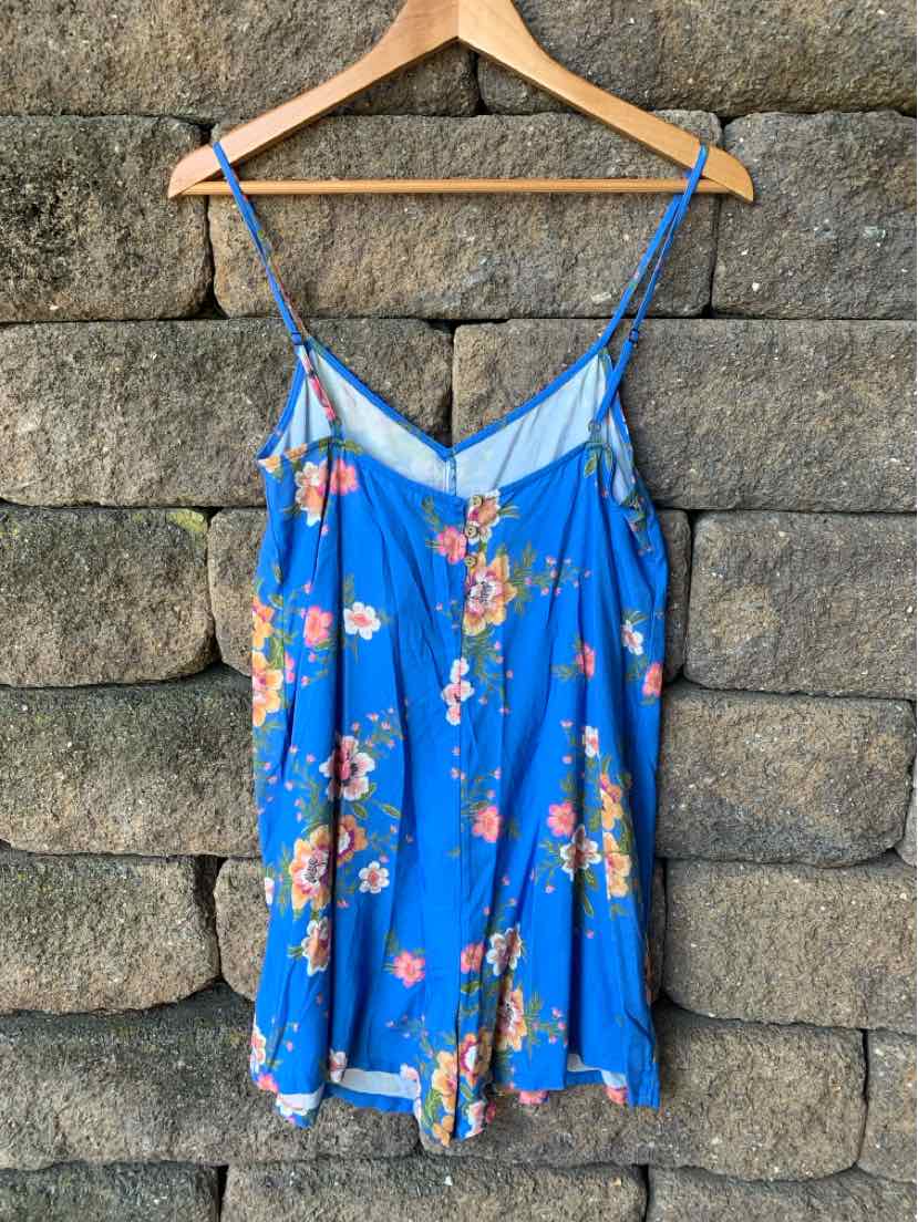 Blue floral print sleeveless camisole with thin adjustable straps and a loose fit.