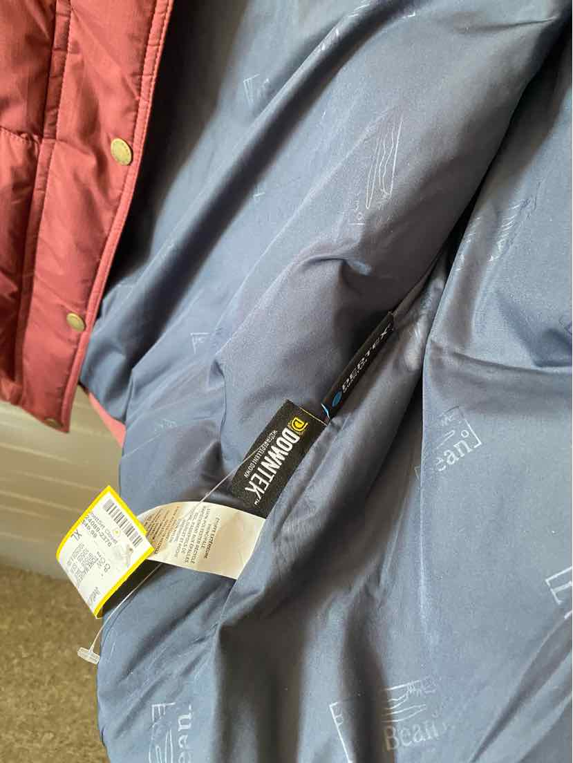 Gray lightweight LL Bean packable jacket with black zipper and beige pull tab, XL size.