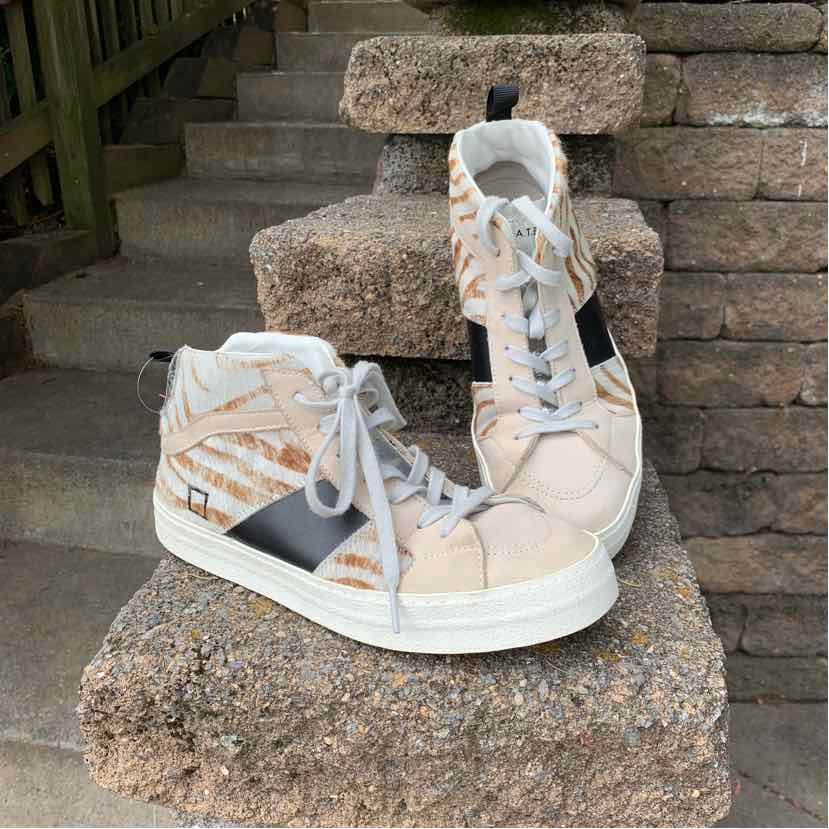 Beige high-top sneakers with white soles, zebra print accents, black side panel, and white laces.