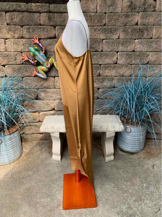Tan sleeveless midi dress with a straight silhouette and spaghetti straps.