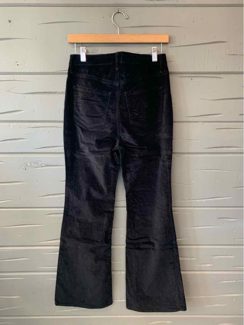 Black Old Navy bootcut pants with a subtle sheen, hanging from a wooden clip hanger.