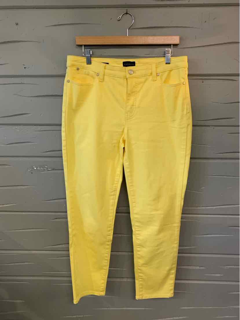 Yellow slim-fit women's pants with front and back pockets, mid-rise waist, and ankle-length hem.