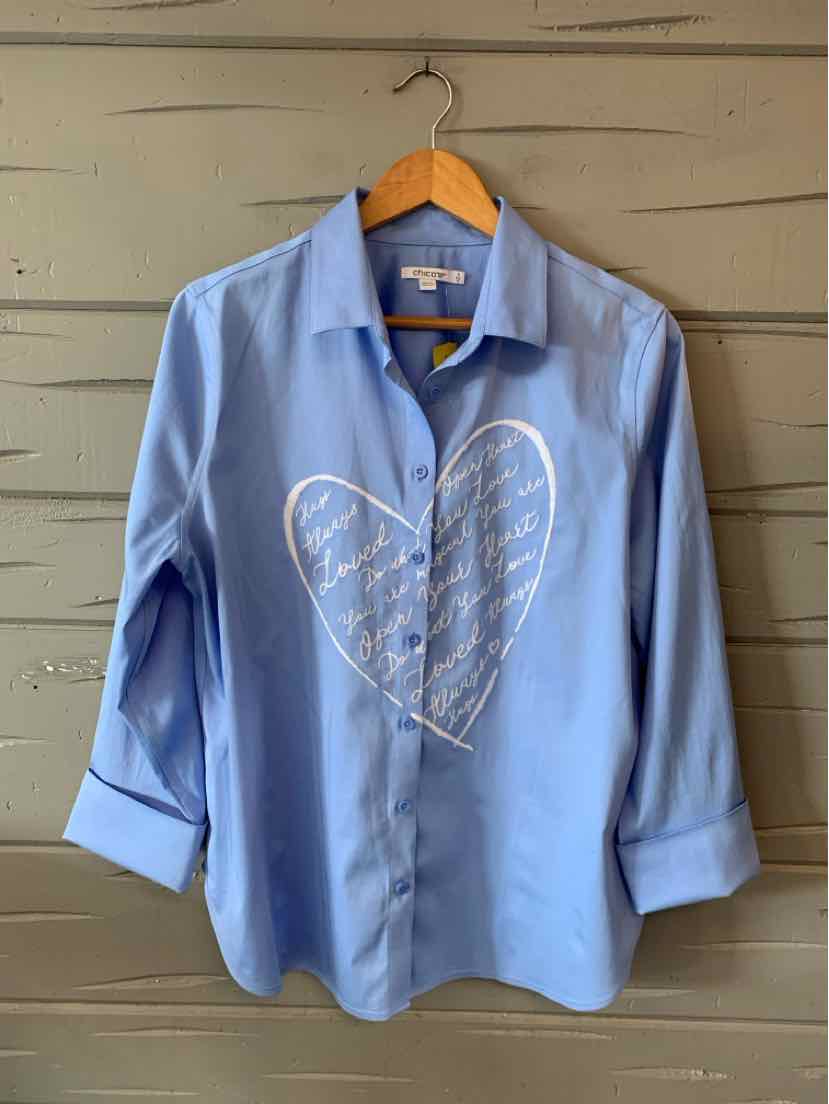 Light blue button-up shirt with long sleeves and a white heart-shaped script design on the front.