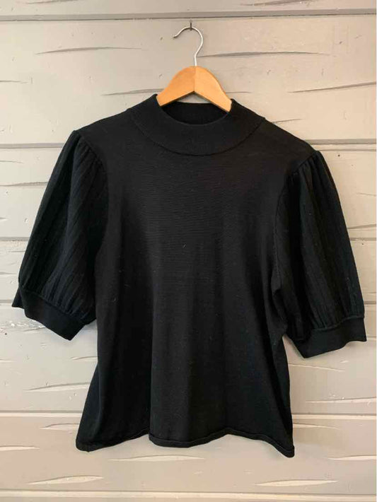 Black knit top with puffed elbow-length sleeves and mock neck, size XL, on wooden hanger.