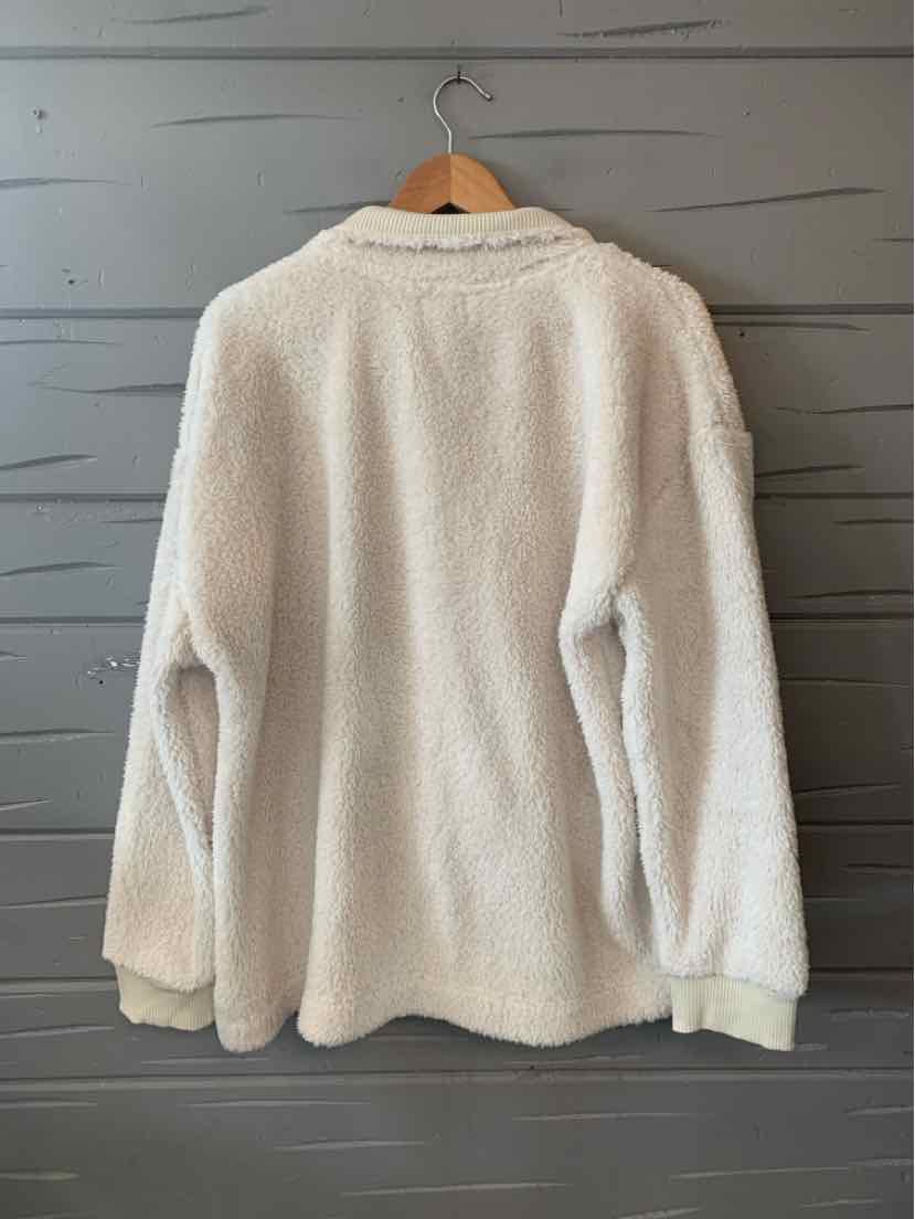 Cream-colored oversized fleece jacket with a high collar and long sleeves.