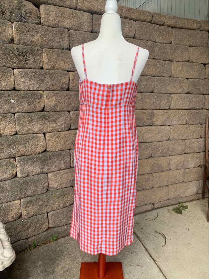 Red and white gingham midi dress with spaghetti straps on mannequin.