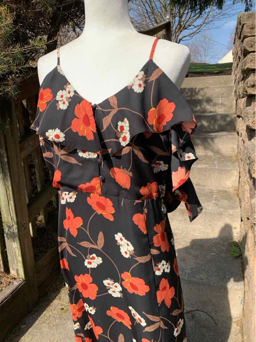 Black floral dress with red and white flowers, spaghetti straps, and ruffled off-shoulder sleeves.