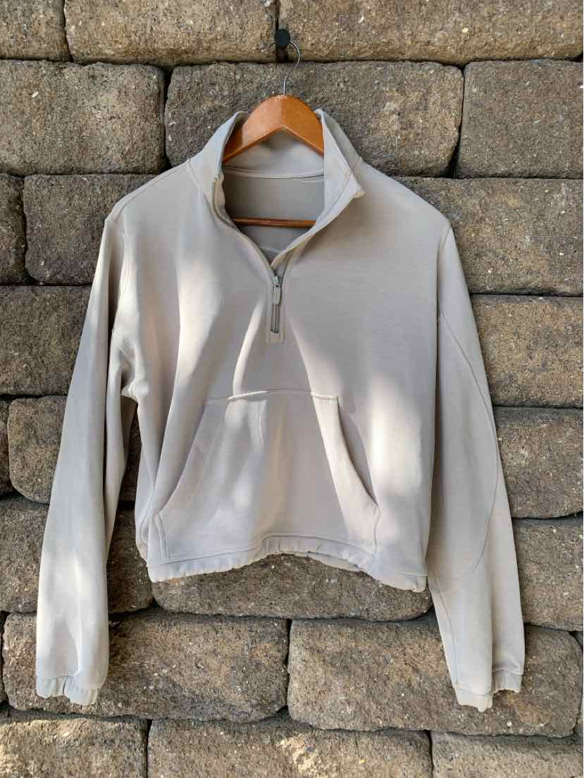 Tan half-zip pullover with a stand collar and kangaroo pocket, soft fabric, size 8.