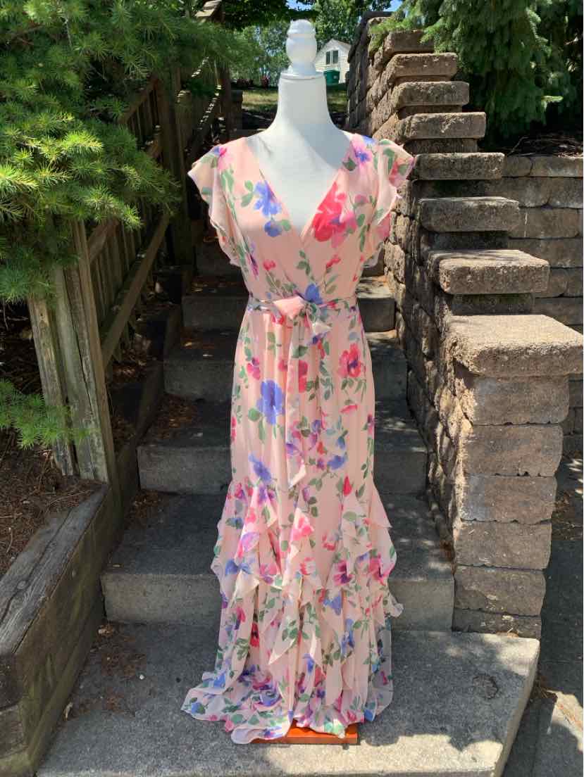 Sleeveless pink floral maxi dress with v-neck, fitted waist, and tiered ruffle hem.