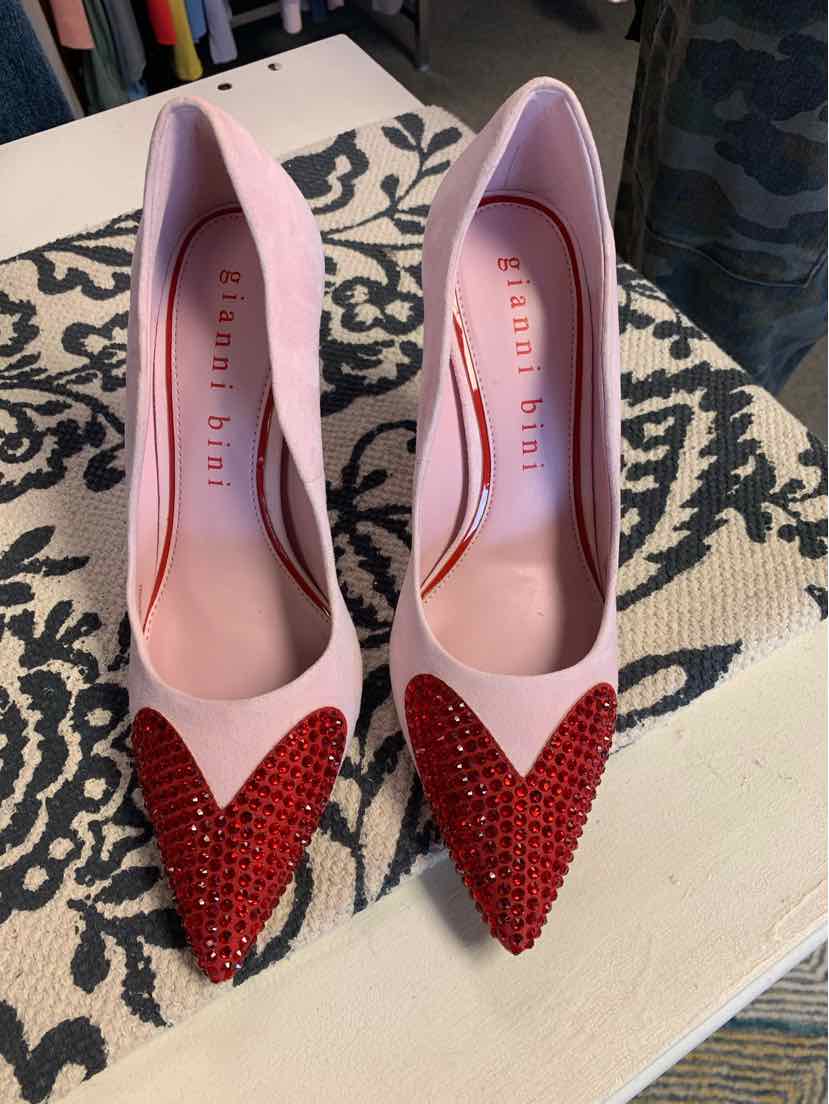Pink pointed-toe heels with red rhinestone-studded toe caps and smooth satin finish.