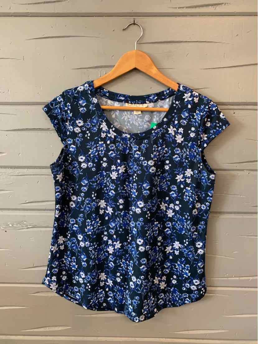 Blue floral short-sleeve blouse with scoop neck and relaxed fit on wood hanger.