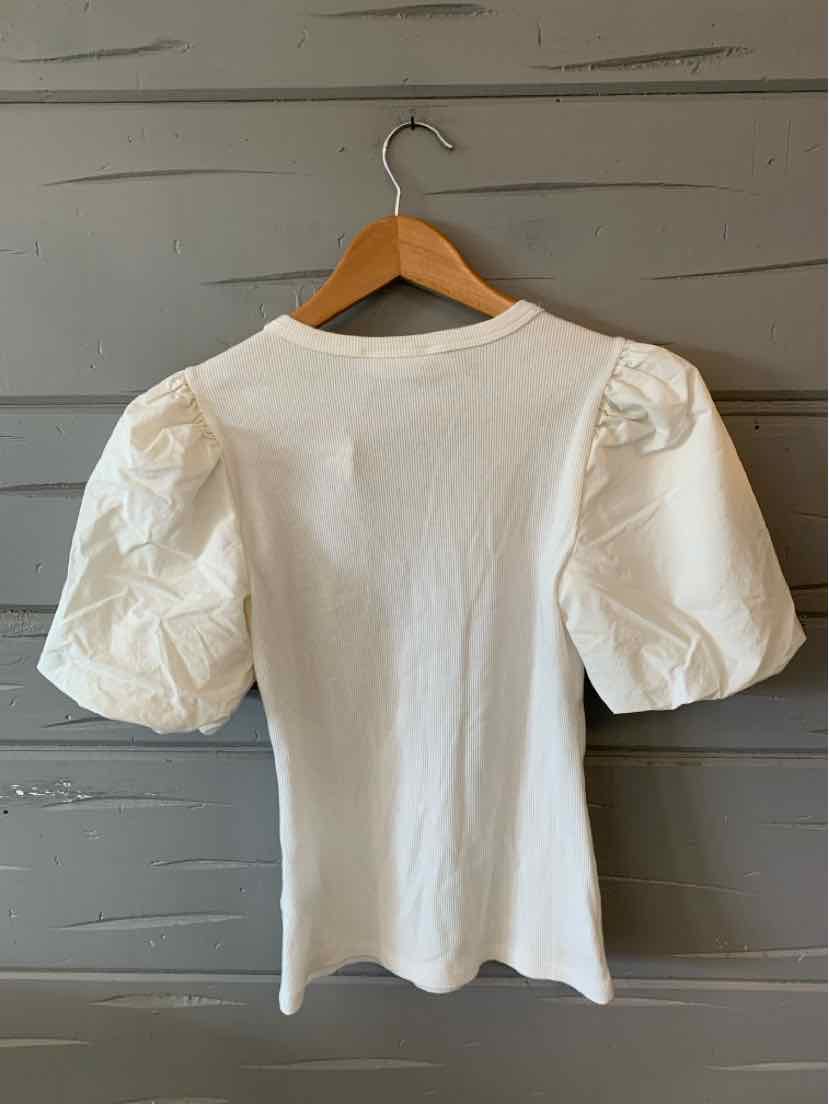 White short-sleeve top with puffed shoulders and fitted ribbed fabric on wooden hanger.