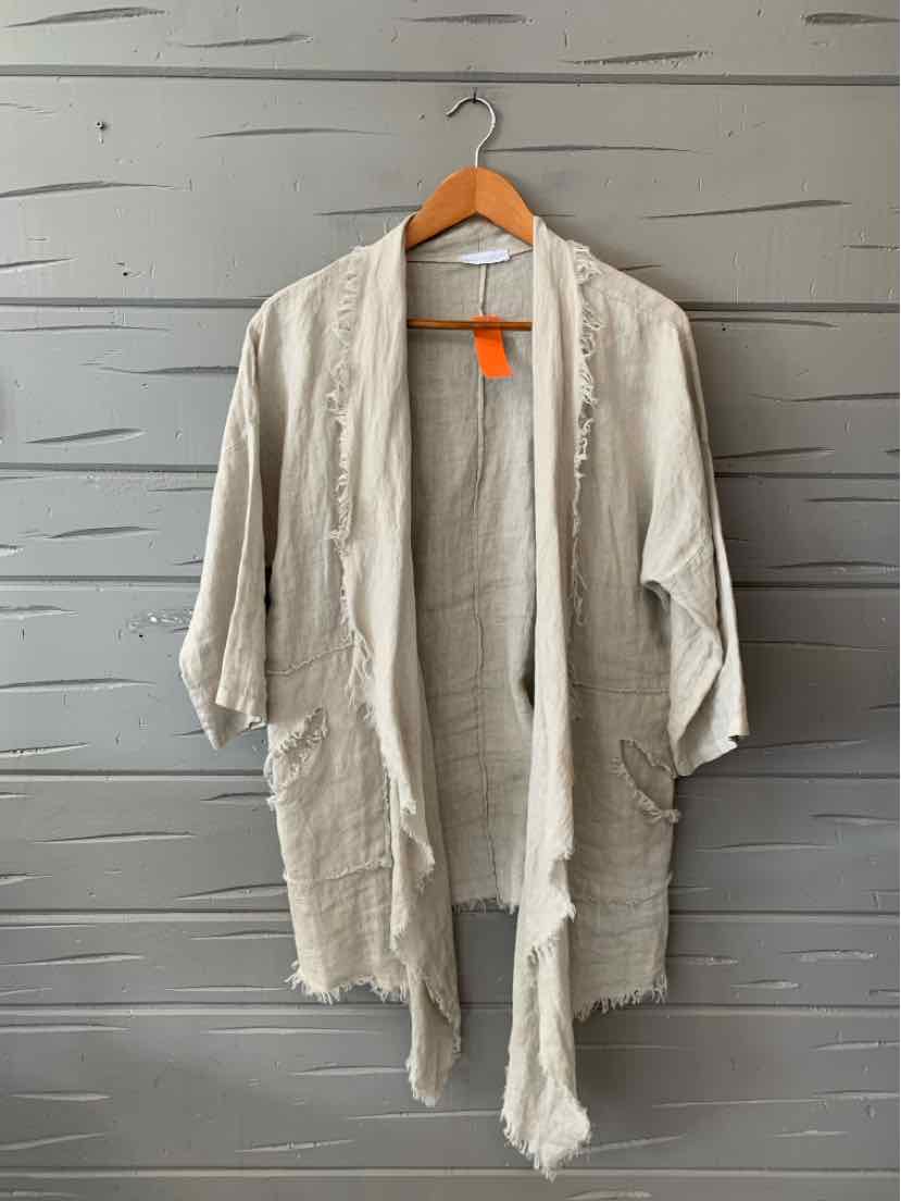 Light tan open-front cardigan with a relaxed fit, long sleeves, and frayed edges hanging on wooden hanger.