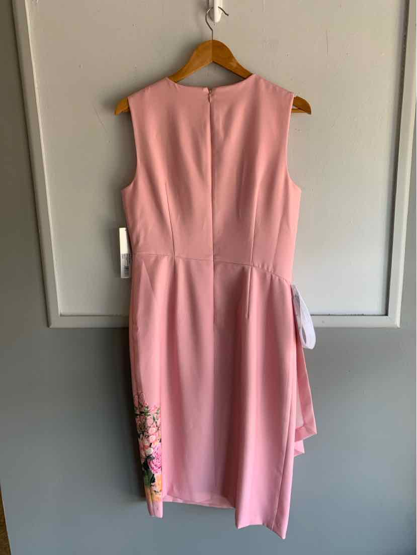 Sleeveless pink dress with floral embroidery on the lower side and asymmetrical hem.