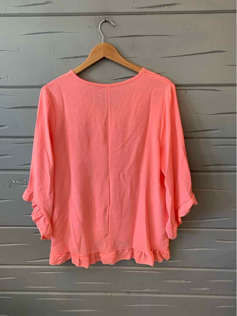 Loose-fit melon-colored blouse with three-quarter ruched sleeves on wooden hanger.
